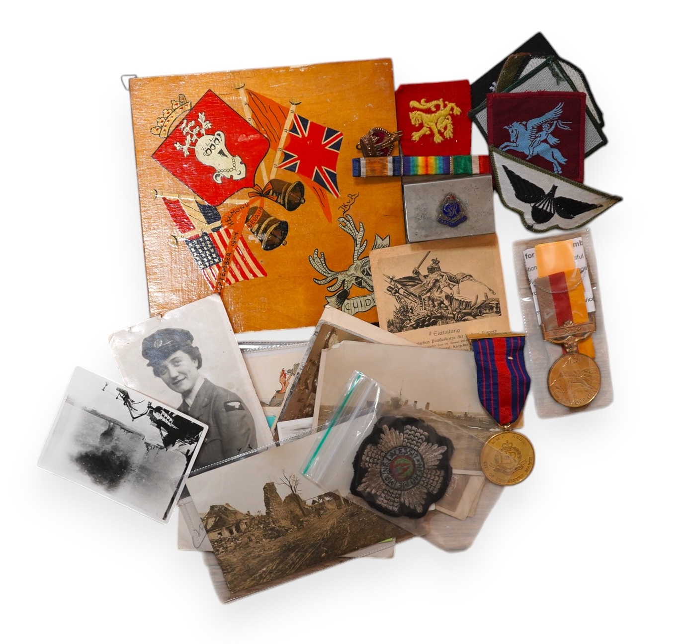 A quantity of various military ephemera to include a Coldstream guards matchbox holder, a death plaque and another 19th century glass plaque, buttons, badges, National Registration Identity Card, various photos and lette